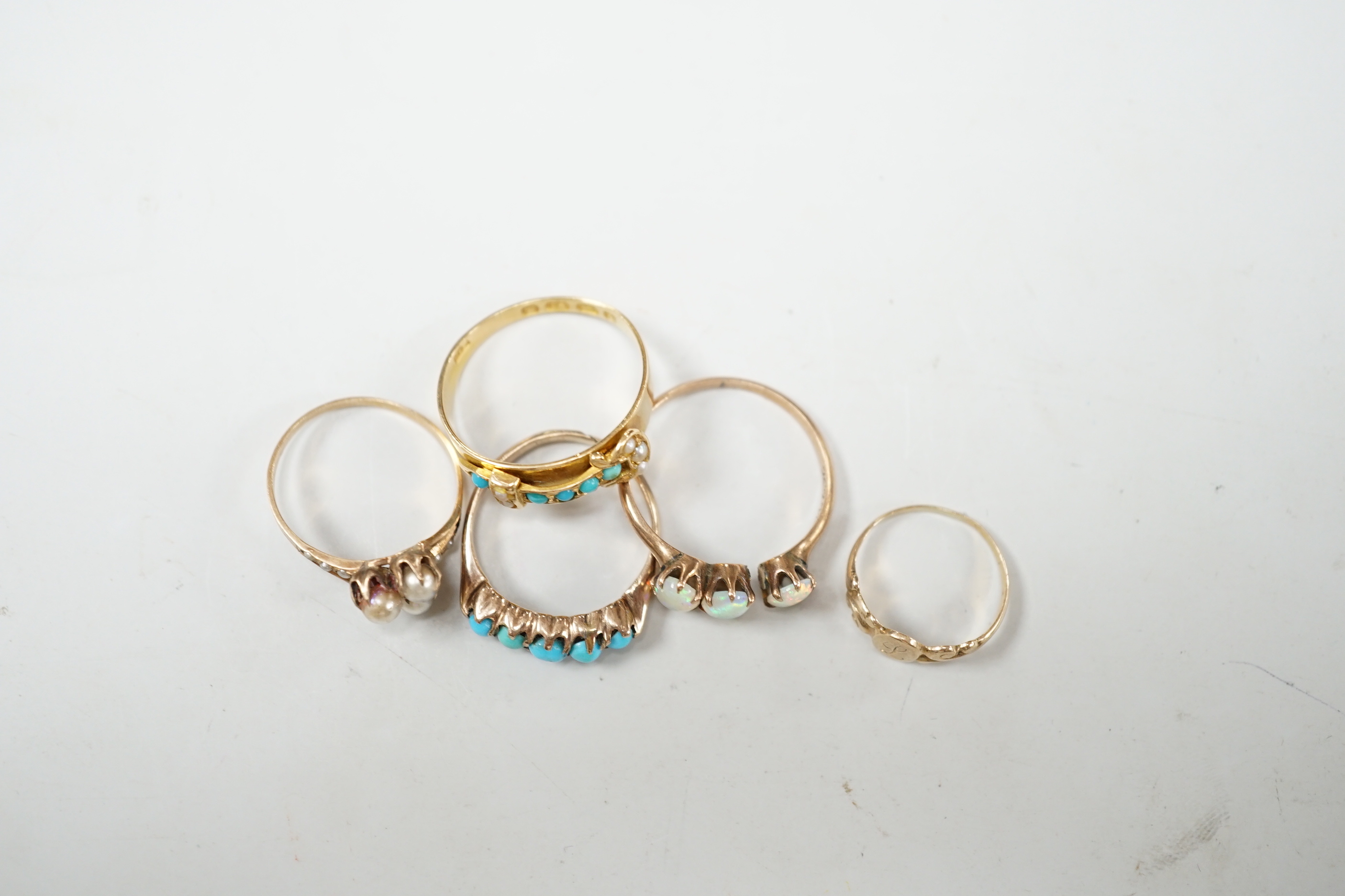 A late Victorian 18ct gold, turquoise and seed pearl set buckle ring, size P and four other yellow metal rings including gem set, gross weight 9 grams (a.f.).